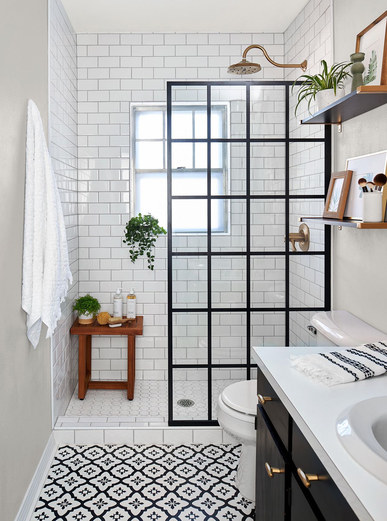 Modern bathroom renovation with grey tiles and a frameless shower